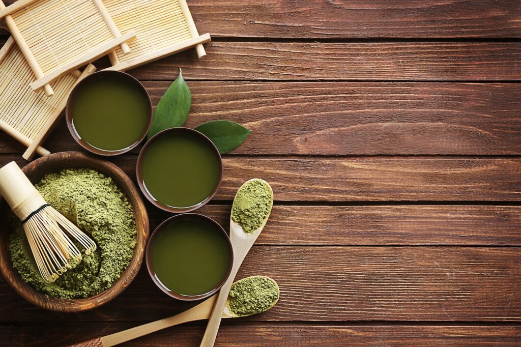 Organic matcha green tea powder with a bamboo whisk